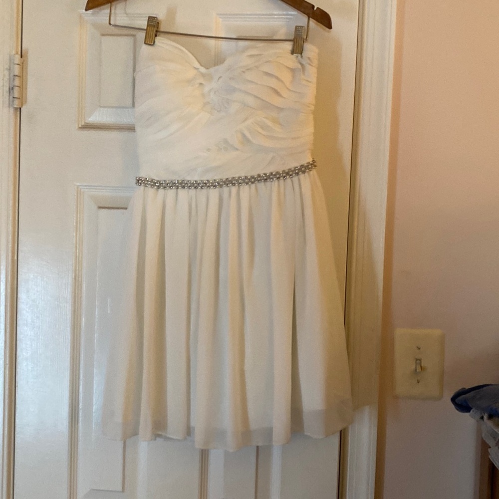 Pristinely white and strapless party dress, beaded bodice